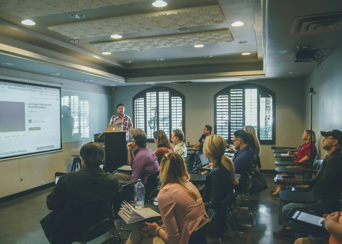 Instructor leading a training session with a room of participants